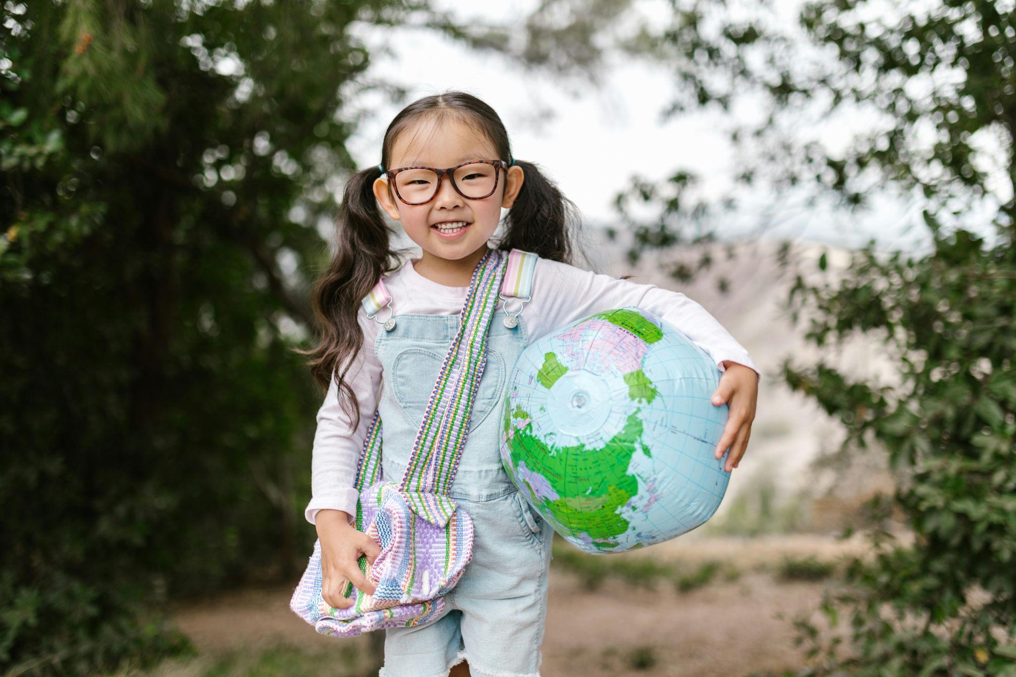 Girl hold globe.