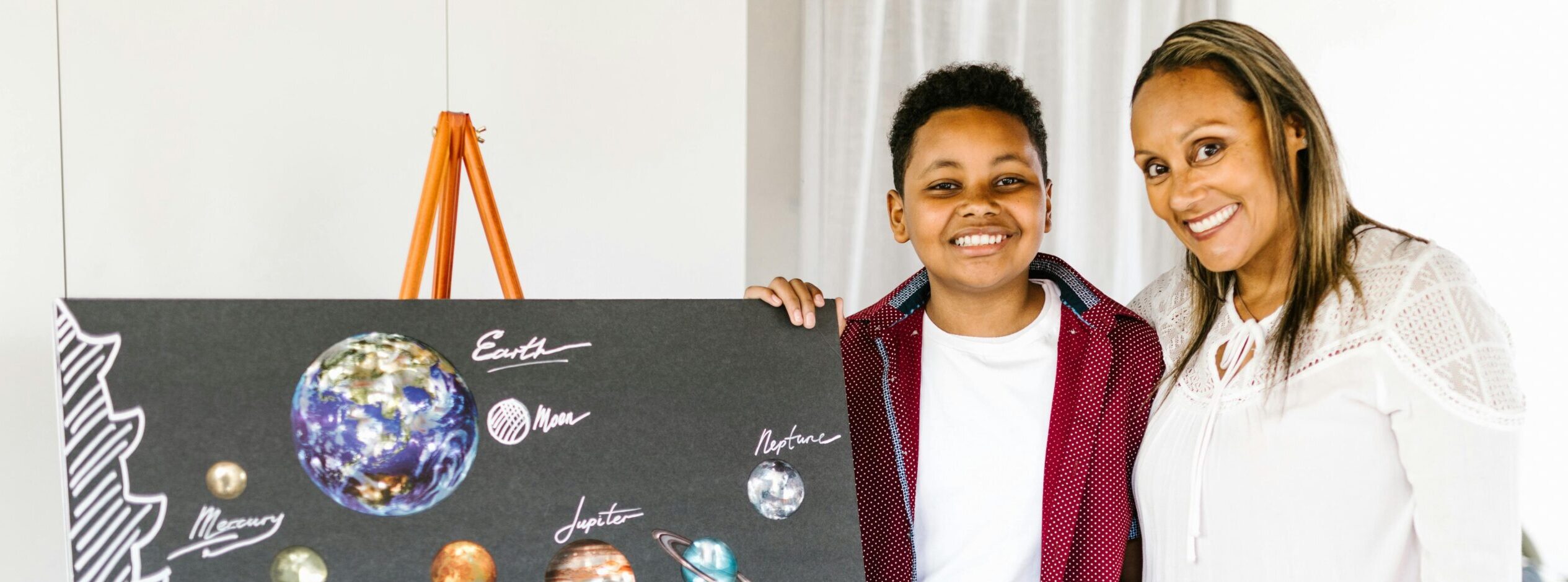 Child presenting the solar system to their mother.