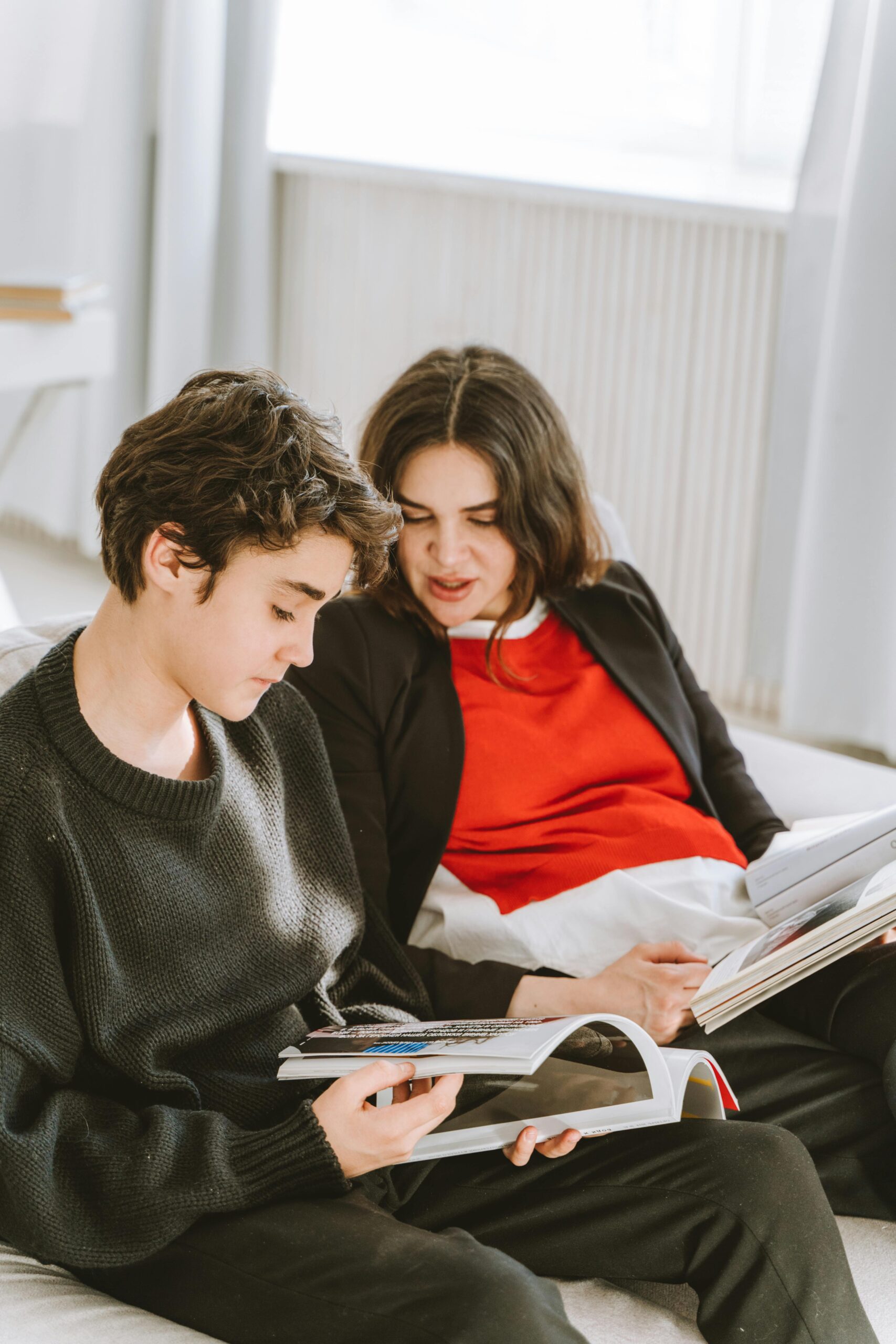 Teenager and parent sitting together