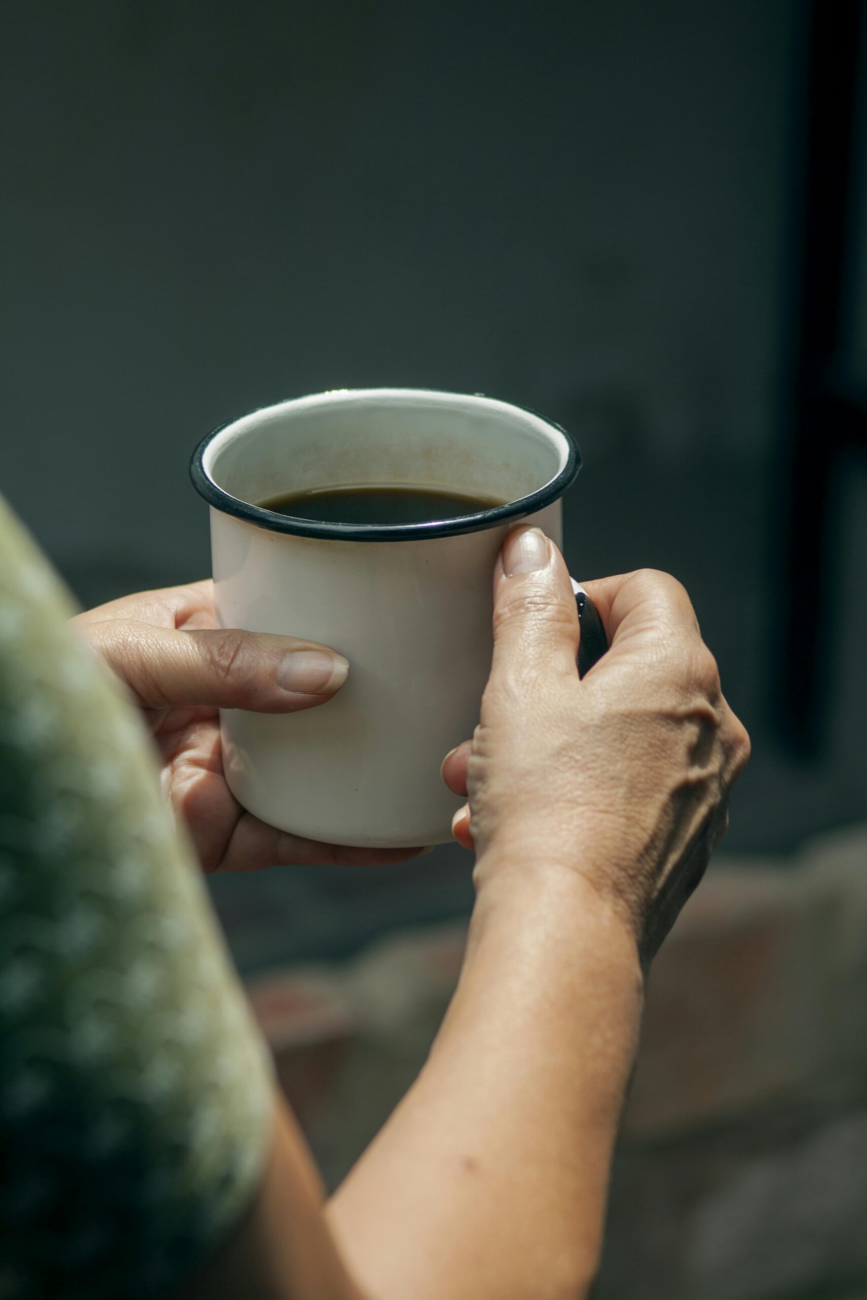 woman's hands hold coffee